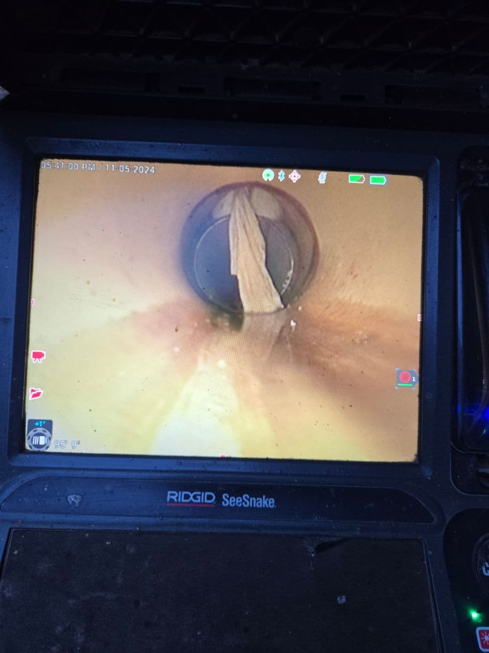 Camera view of a pipe showing debris, indicating potential blockage or plumbing issue.