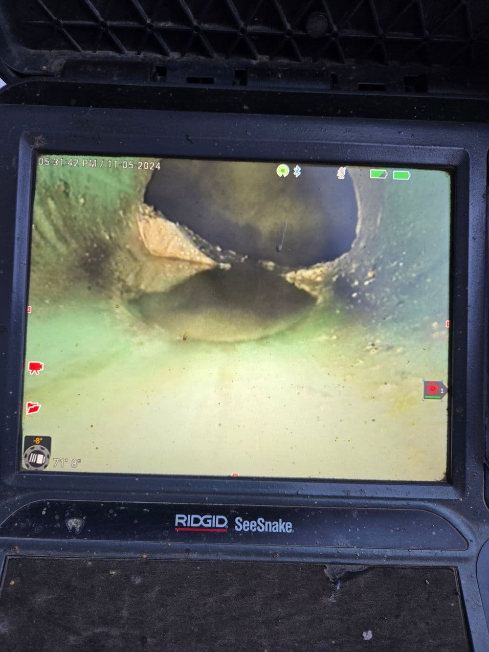 Pipe inspection view on a RIDGID SeeSnake monitor showing interior details and structure.